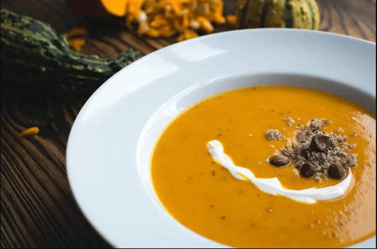 there is a bowl of soup with a spoon in it