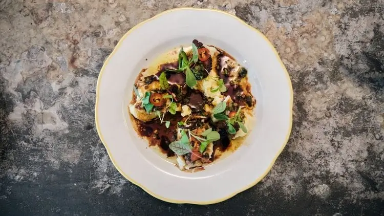 there is a plate of food on a table with a fork