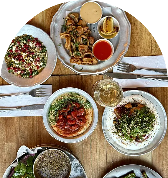 several plates of food are on a table with silverware