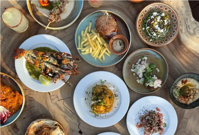 a close up of a table with plates of food and drinks