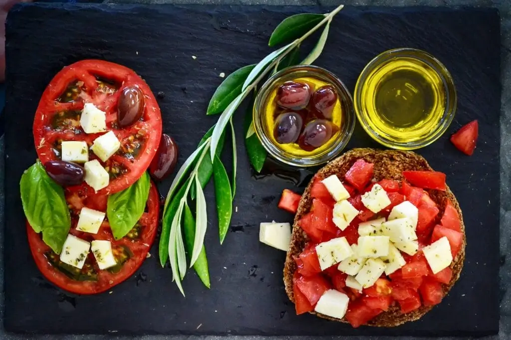 there are two slices of bread with tomatoes and cheese on them