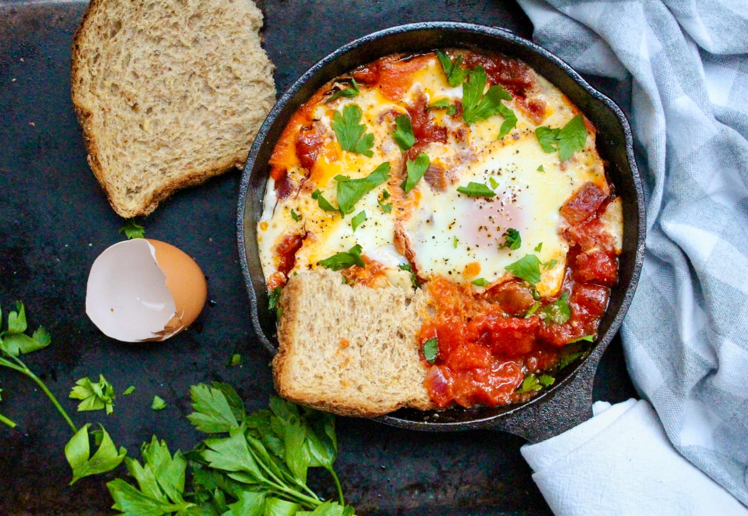 there is a pan with eggs and bread on a table