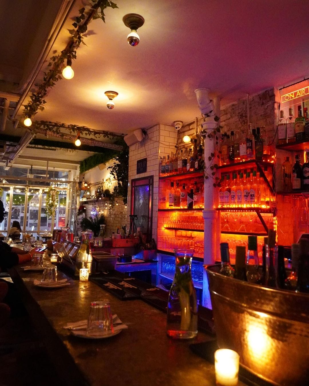 there is a bar with a lot of bottles and candles