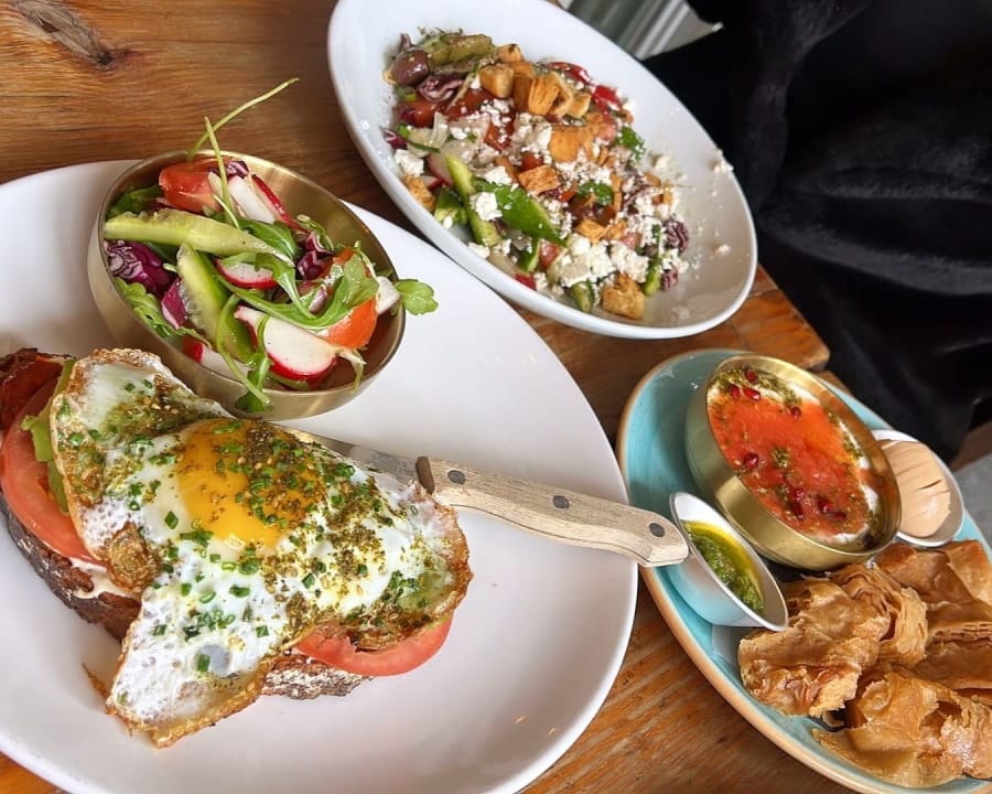 there are three plates of food on a table with a bowl of chips